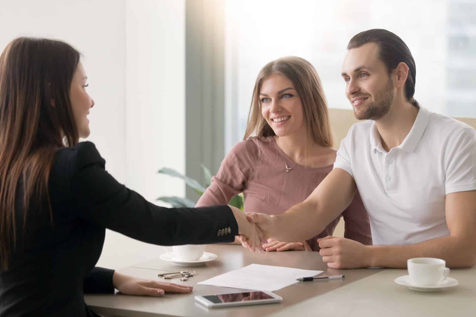 Happy couple signing a mortgage contract with Southern Elite Mortgage