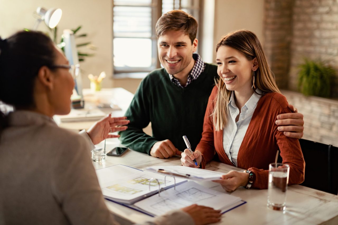 Happy couple signing a mortgage contract with Southern Elite Mortgage